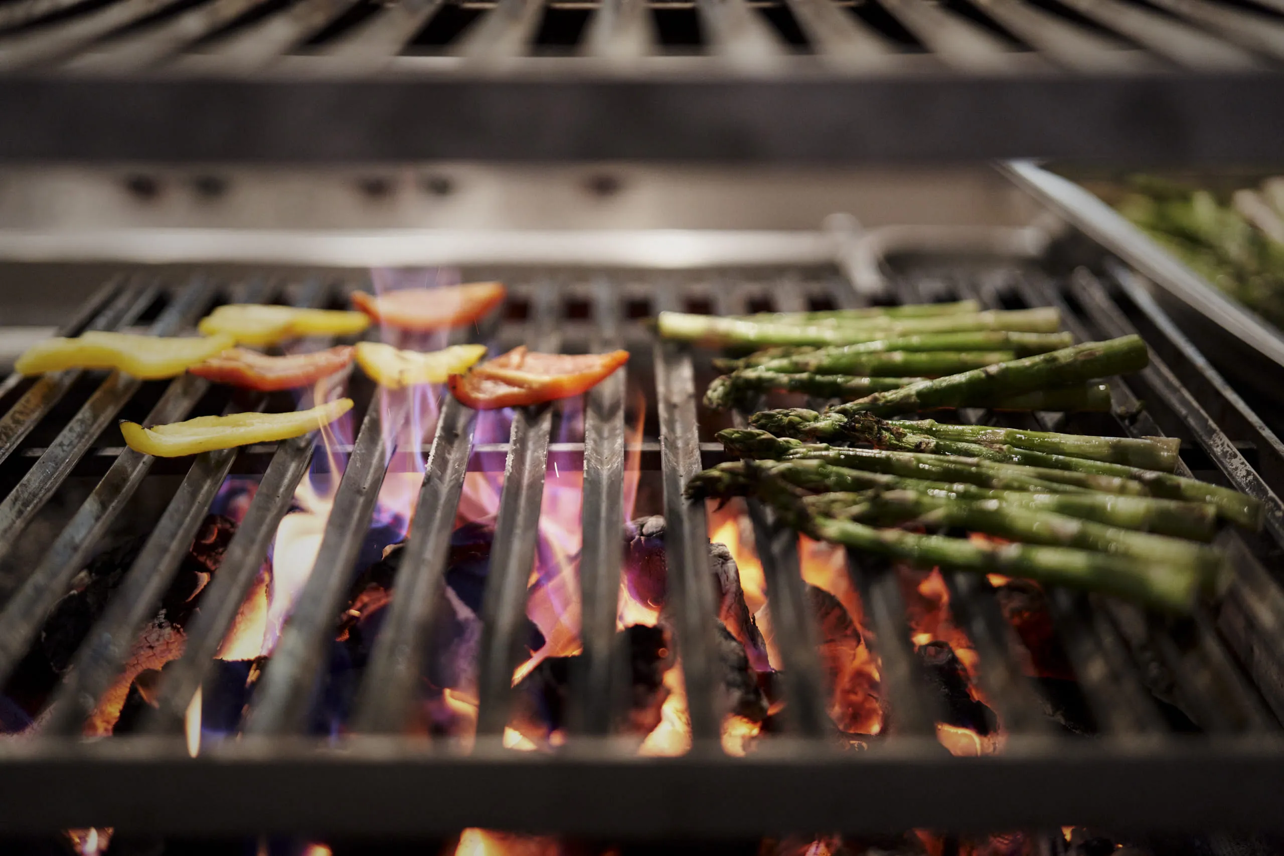 Grillgemüse auf einer Grillfläche mit Flammen